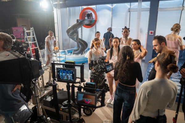 A large crew and cast on a studio set