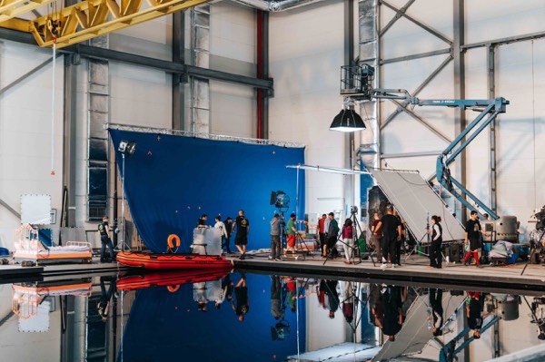 A studio with a water tank and blue backdrop for a commercial shoot