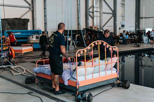 Preparing a bed set in a sound stage