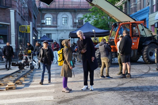 Crew and cast in a street during an outdoor shoot