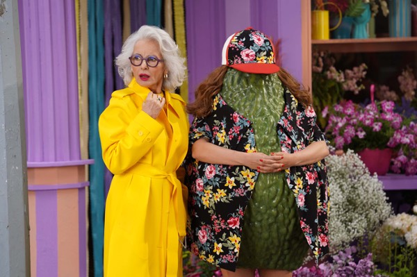 Actors in bright costumes on a colourful set