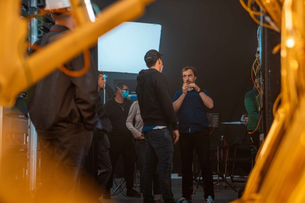 Actor and crew on set, seen through a frame