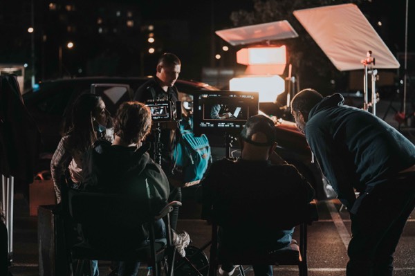 Crew with camera and lights on a night shoot
