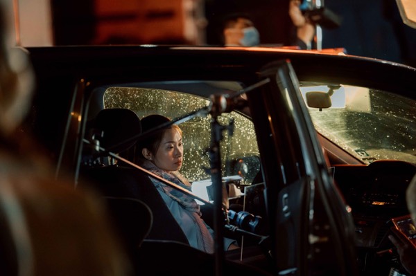 Actress at the wheel, filmed from inside the car