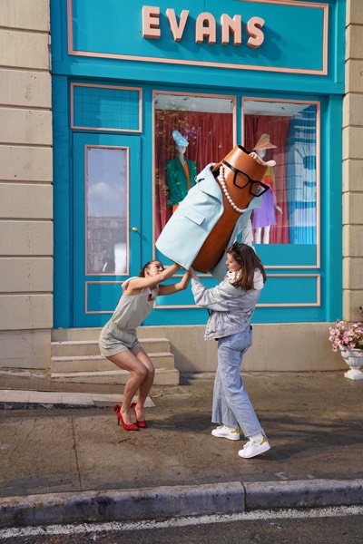 Actor in a product costume outside a shop window on a street shoot