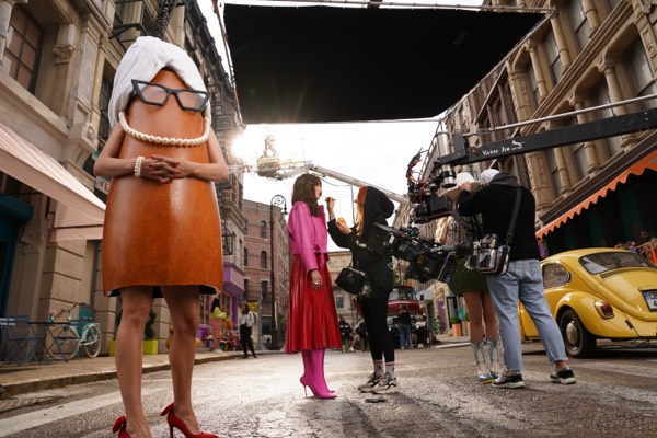 Actors in product costumes and crew in a street