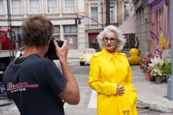 Photographer shooting an actress in a yellow raincoat