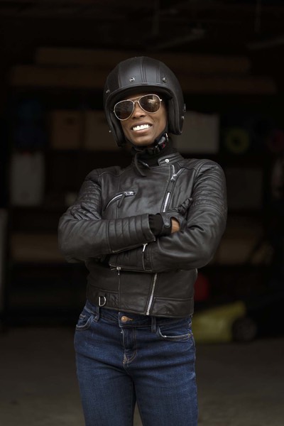 Portrait of an actress in a leather jacket and helmet behind the scenes