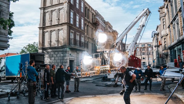 Film crew and equipment in a square in an old town
