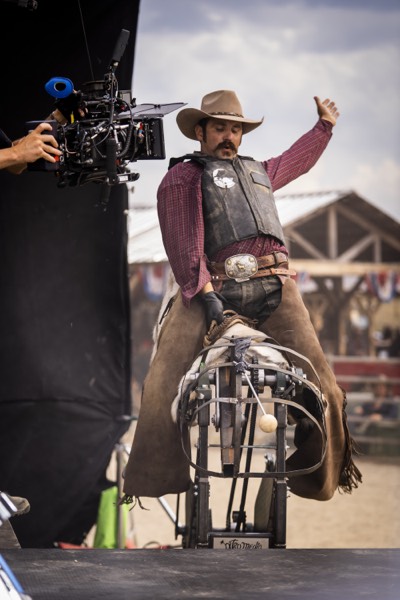 Cowboy on a mechanical bull in front of the camera