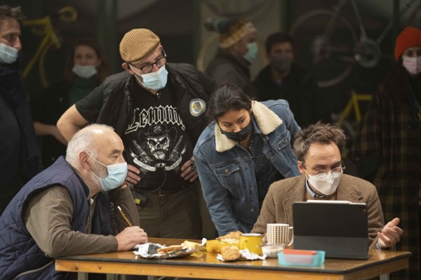 Crew in masks going through the script at a table
