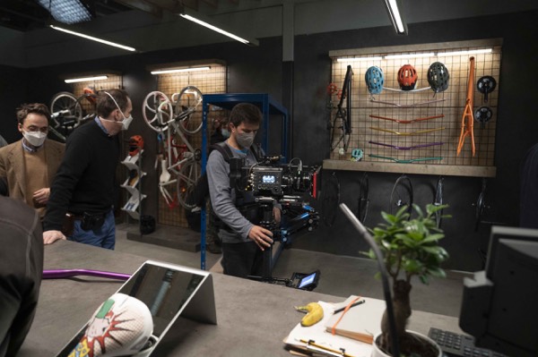 Dark studio set with crew and lighting