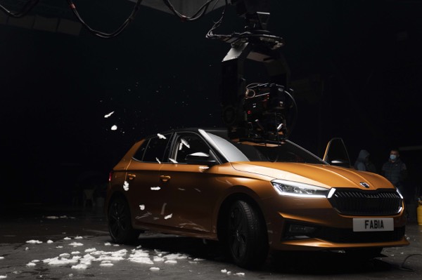 Orange car in a dark studio for a car commercial