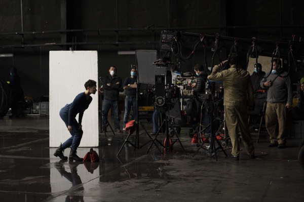 Crew and equipment in a large dark studio